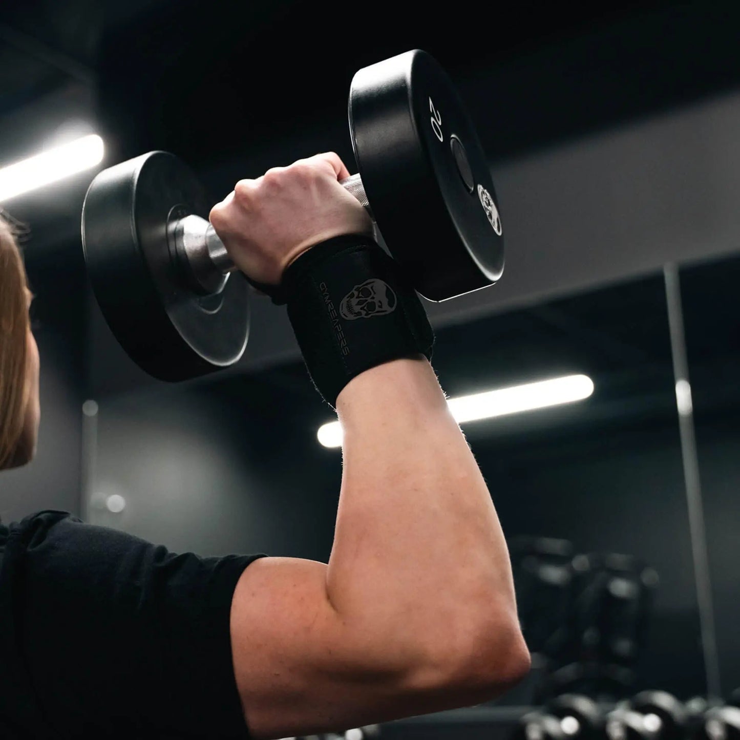 Black gym wrist wraps by My Store 2, featuring adjustable straps and reinforced stitching for wrist support during workouts.