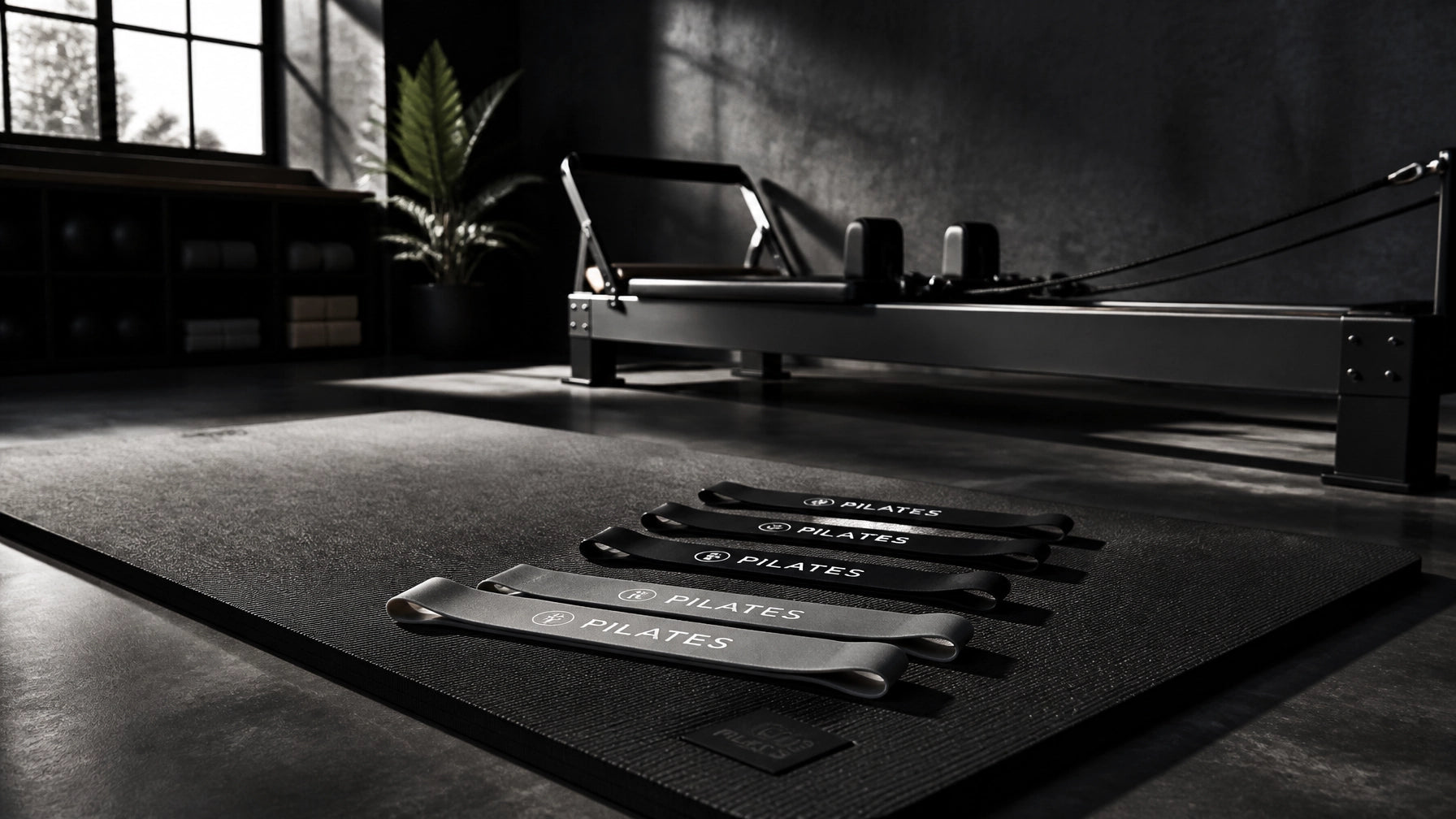 Home Pilates equipment for studio includes resistance bands and a reformer in a modern workout space.