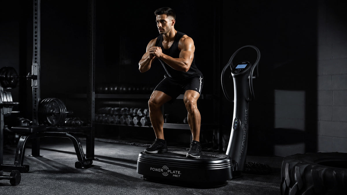 Man performing squats on a vibration plate for weight loss, highlighting vibration plate weight loss benefits.