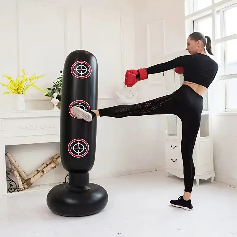 Woman practicing kickboxing on the Ultimate Inflatable Punching Bag for home workouts in a stylish indoor setting.