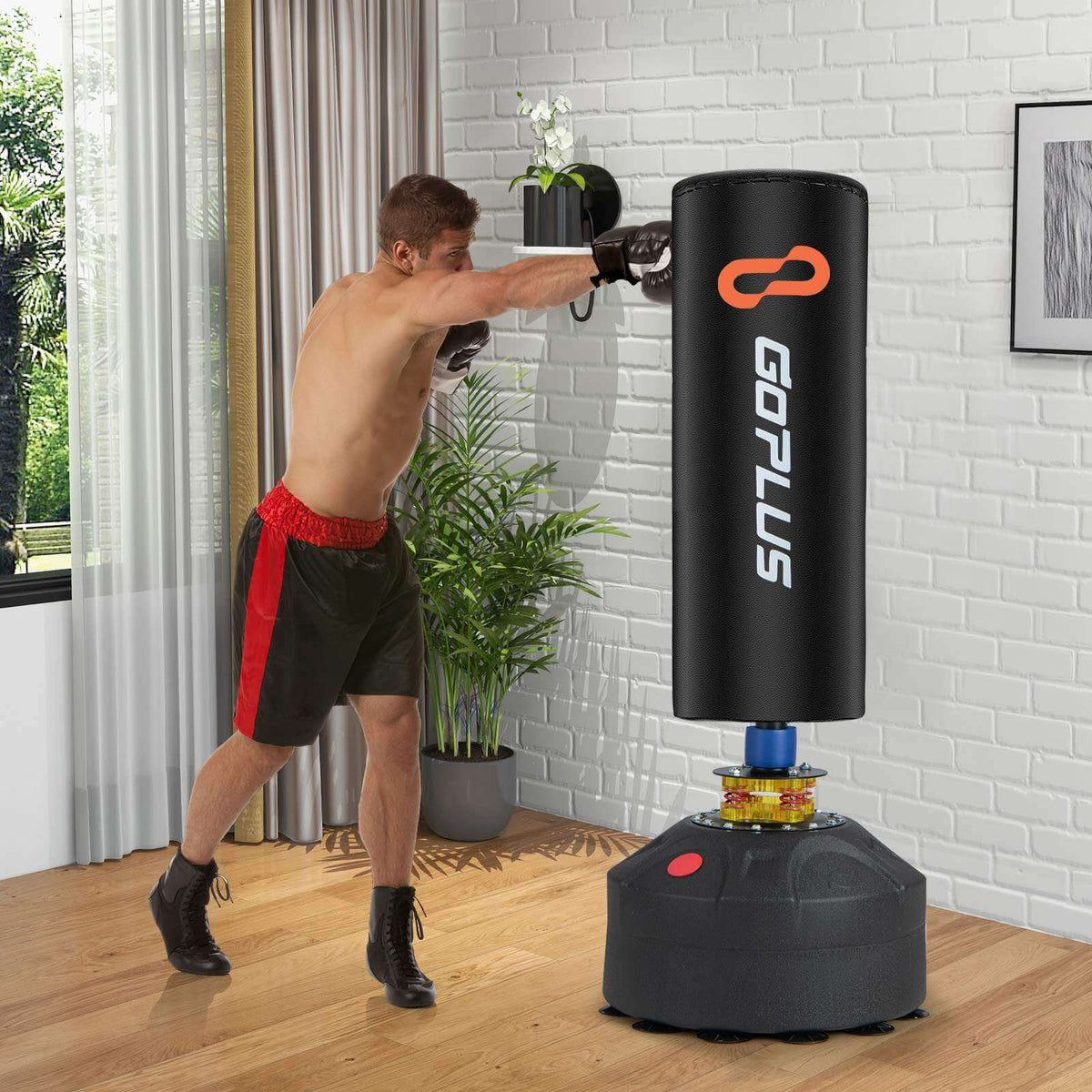 Free standing punching bag with gloves used for a home workout in a stylish living room setup.
