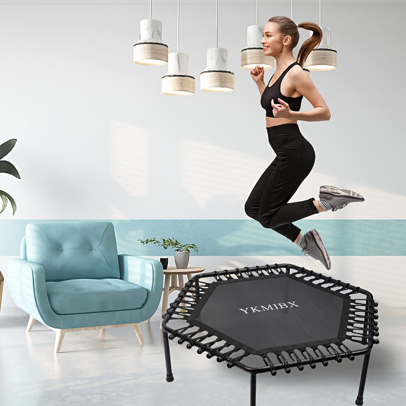 Young woman jumping on a hexagonal quiet bounce fitness trampoline in a stylish home gym setting.