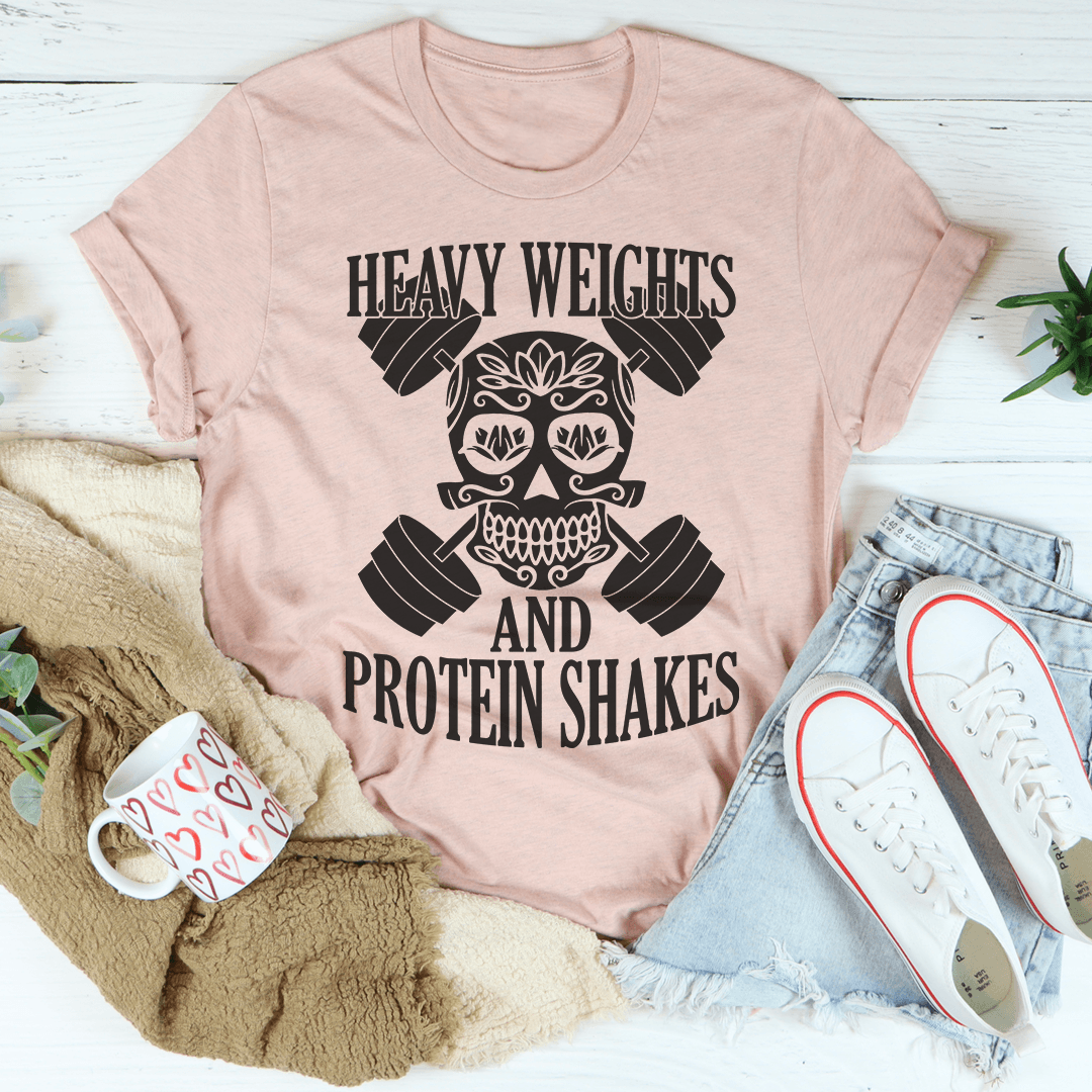 Heavy Weights And Protein Shakes Tee in Heather Prism Peach with skull and weights design, perfect for casual or active wear.