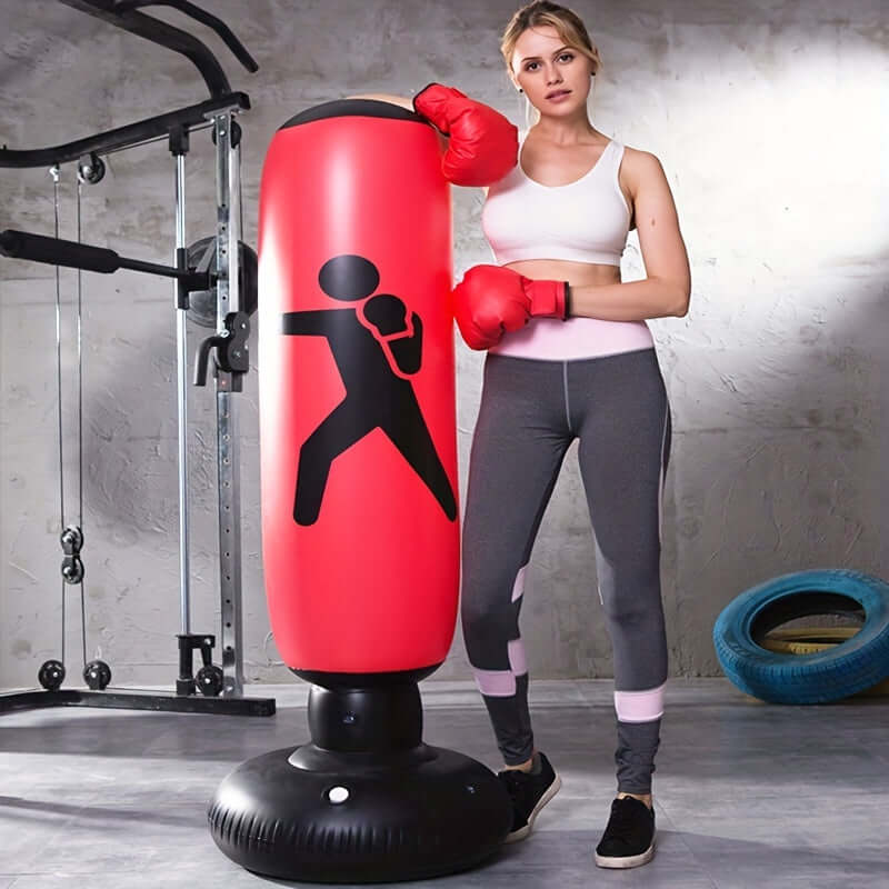 Durable inflatable boxing bag stand used in a home gym by a woman in workout gear, promoting fitness training.