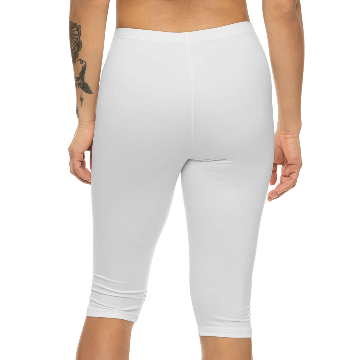 Women's white athletic capri leggings viewed from the back, perfect for yoga and gym workouts.