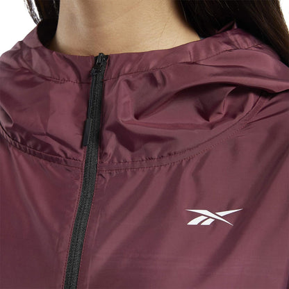 Reebok women's Workout Ready hooded jacket in black, with front zipper and adjustable drawstrings, suitable for activewear.