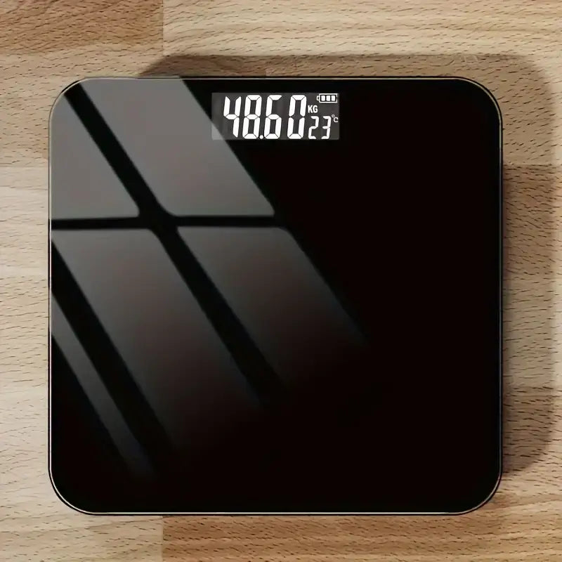 High precision battery powered body weight scale displayed on wooden surface showing accurate weight measurement.