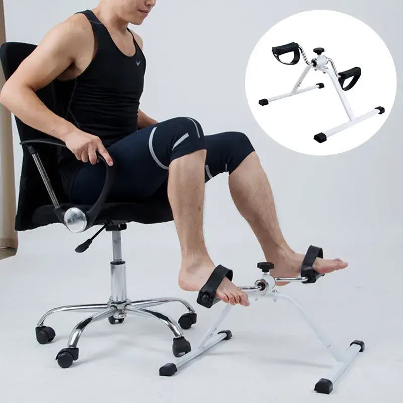 Man using a household portable pedal exerciser for home workouts while seated in a chair.