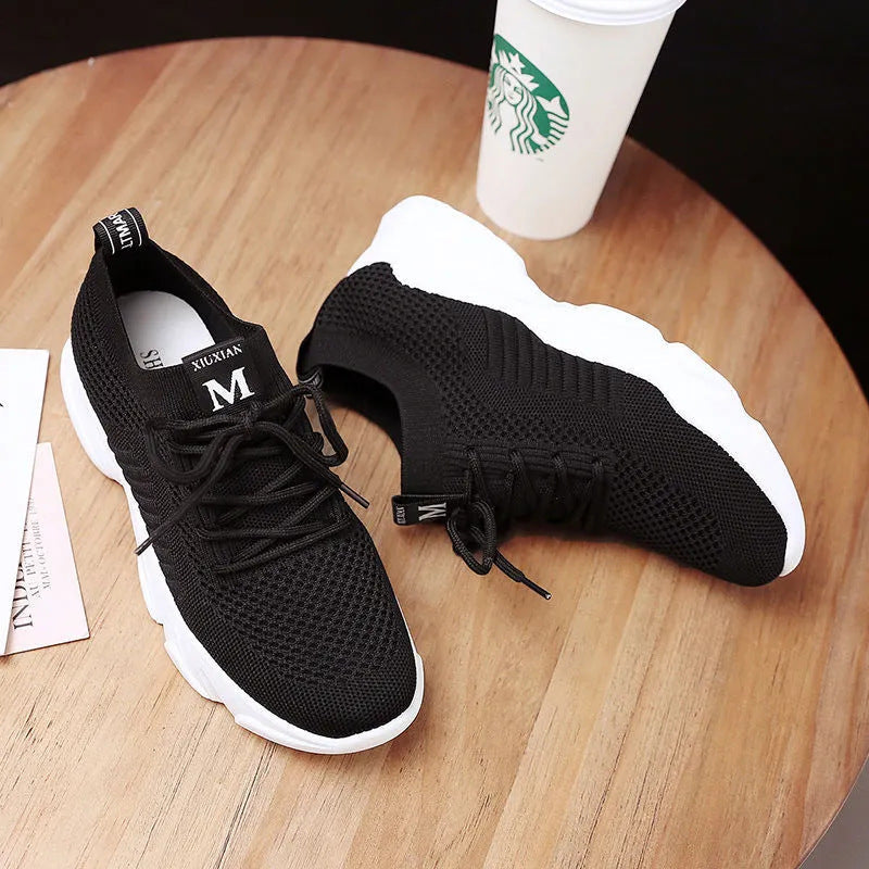 women's casual sports sneakers in black with breathable mesh upper and white outsole, perfect for running and walking.
