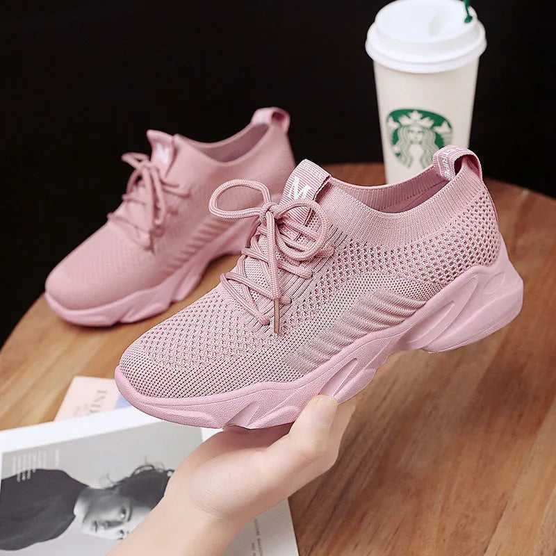 Women's casual sports sneakers in pink color, designed for comfort and style, perfect for walking and running.