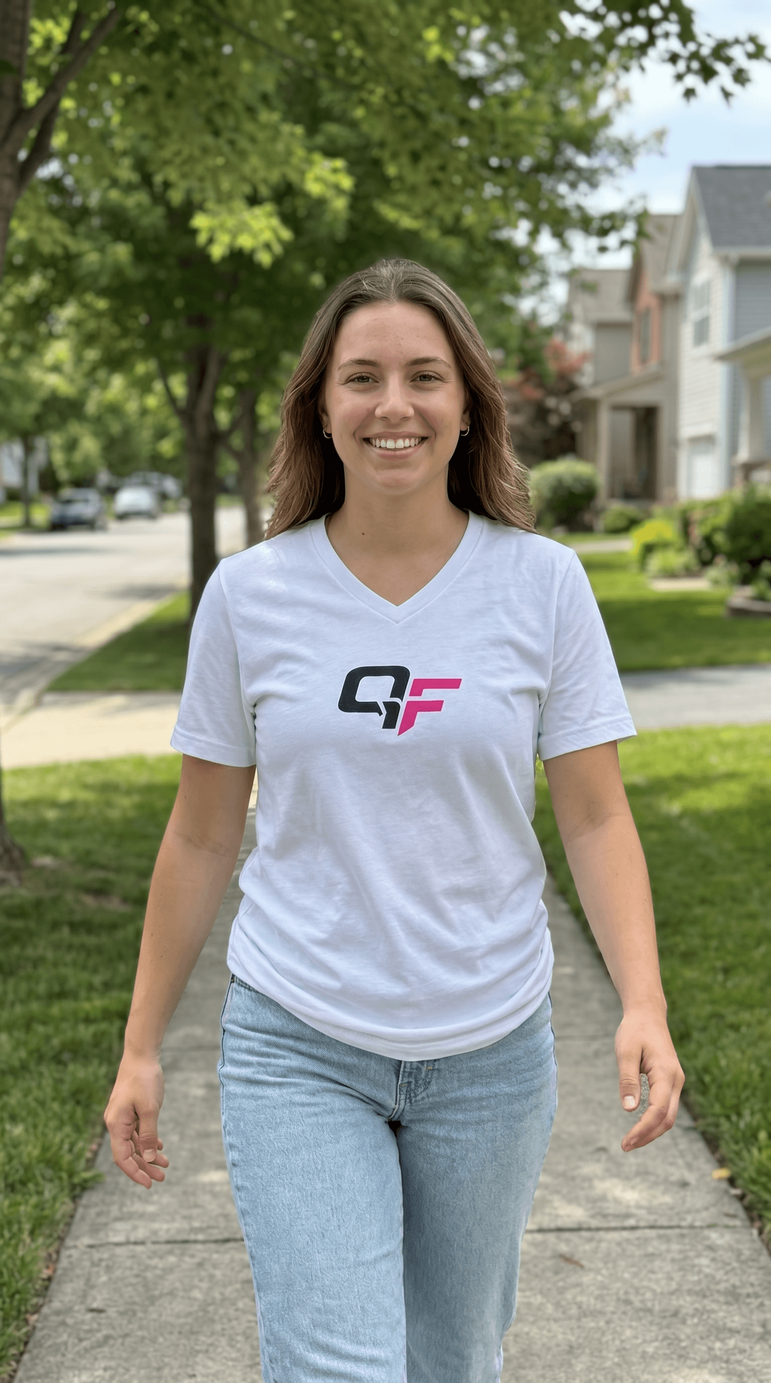 Woman walking outdoors in a white v-neck workout t-shirt, showcasing casual and versatile activewear style.