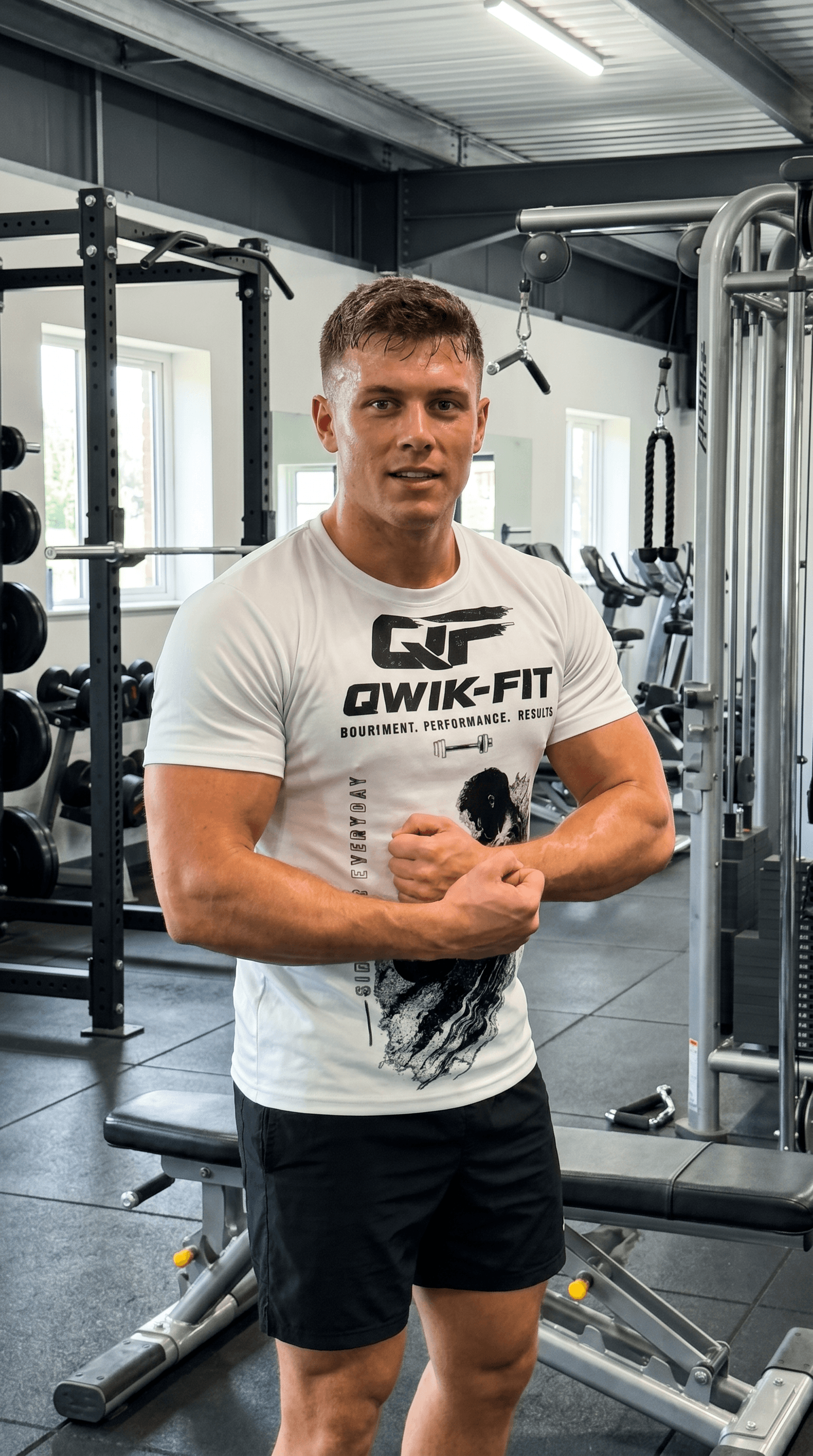 Unisex athletic cut and sew tee showcased in a gym by a man demonstrating fitness style and comfort.