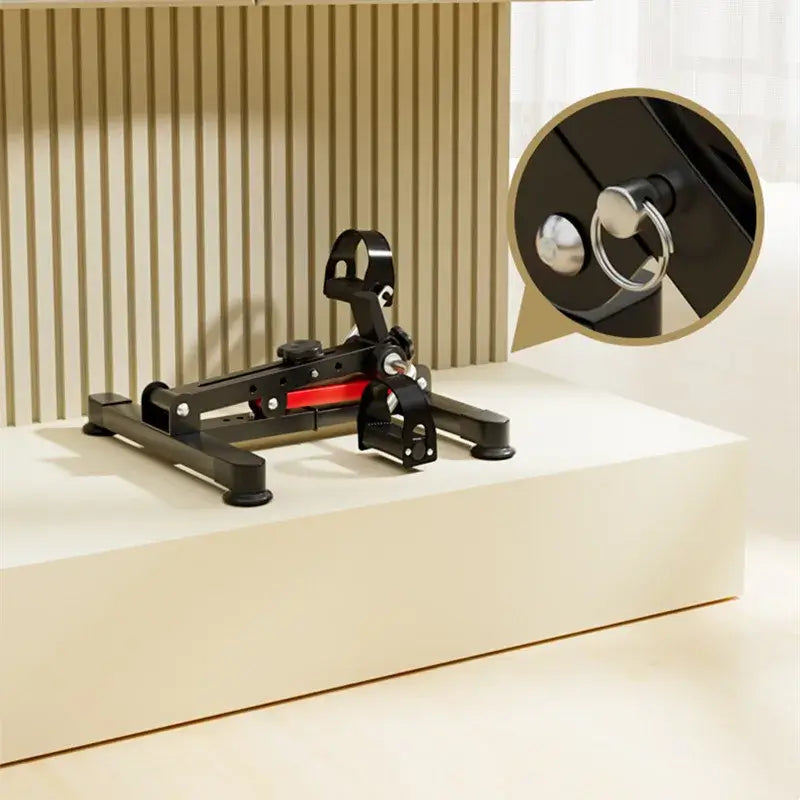 Mini Foldable Exercise Bike showcased on a stylish surface, highlighting its compact design and adjustable features.