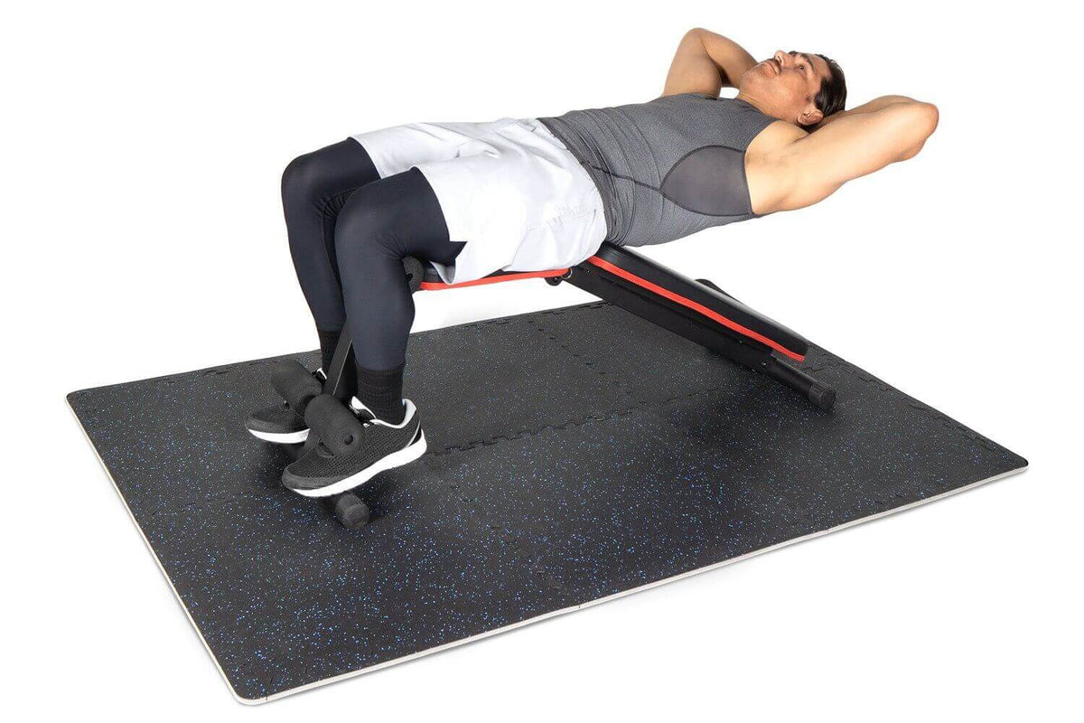 Man performing abdominal exercises on a rubber top exercise mat for effective home workouts.