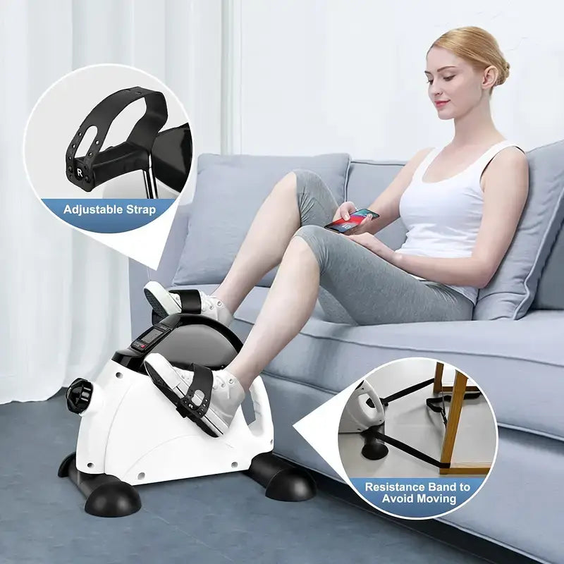 Woman using a mini pedal exercise machine for home fitness, featuring adjustable strap and resistance band.