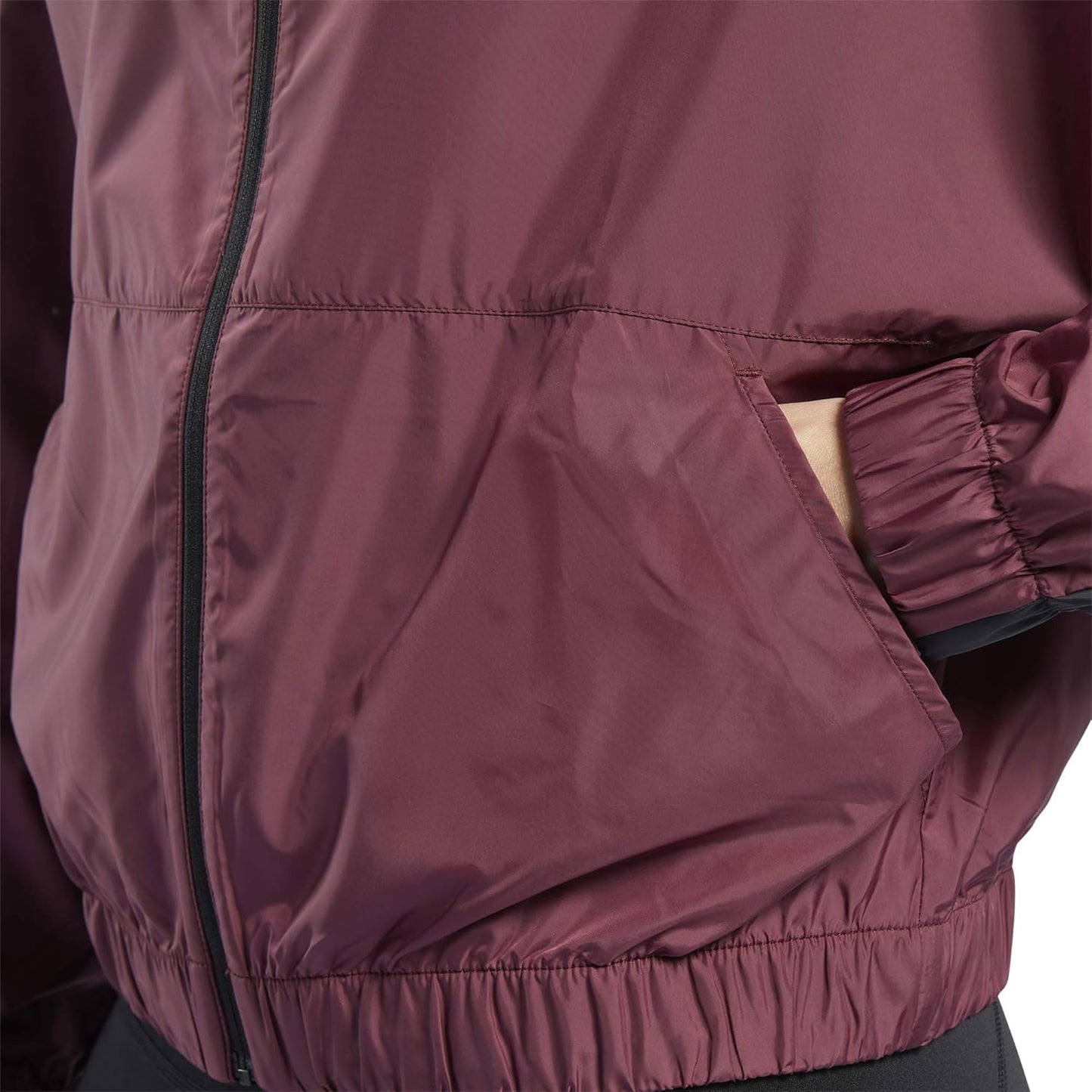 Reebok women's workout ready hooded jacket in black, featuring a front zipper, hood, and athletic fit for activewear.