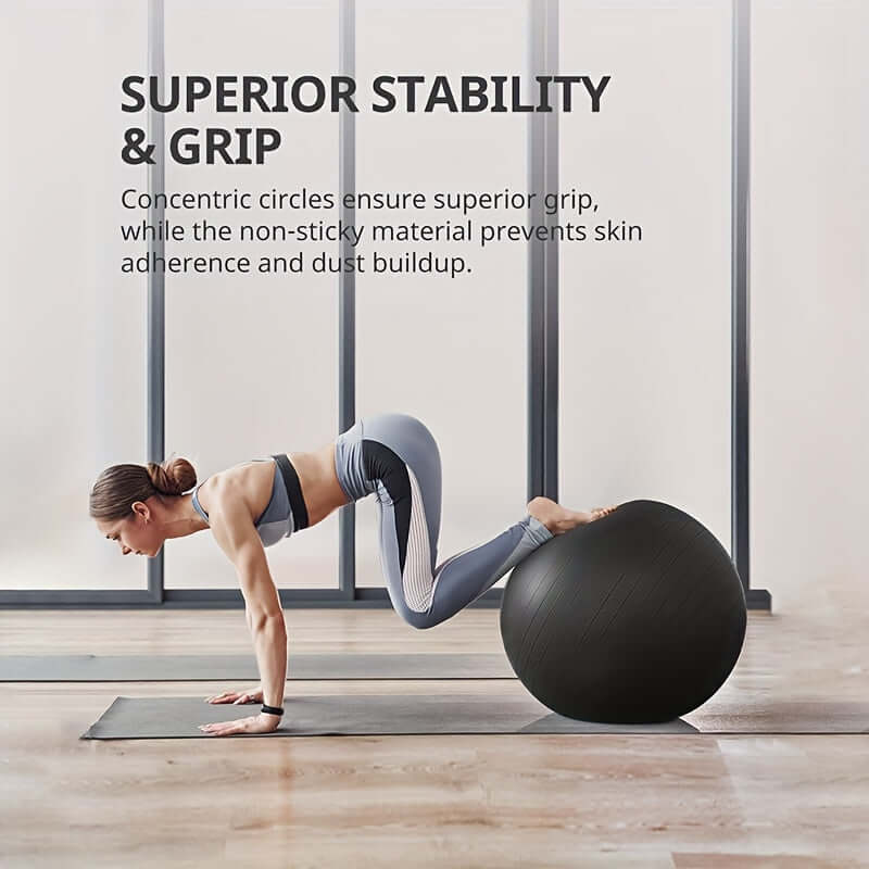 Woman demonstrating stability on an explosion-proof yoga ball with pump in a modern gym setting.