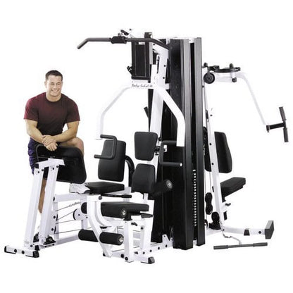 Body Solid EXM3000LPS commercial double stack gym with three workout stations and multiple weight stacks for full-body training.