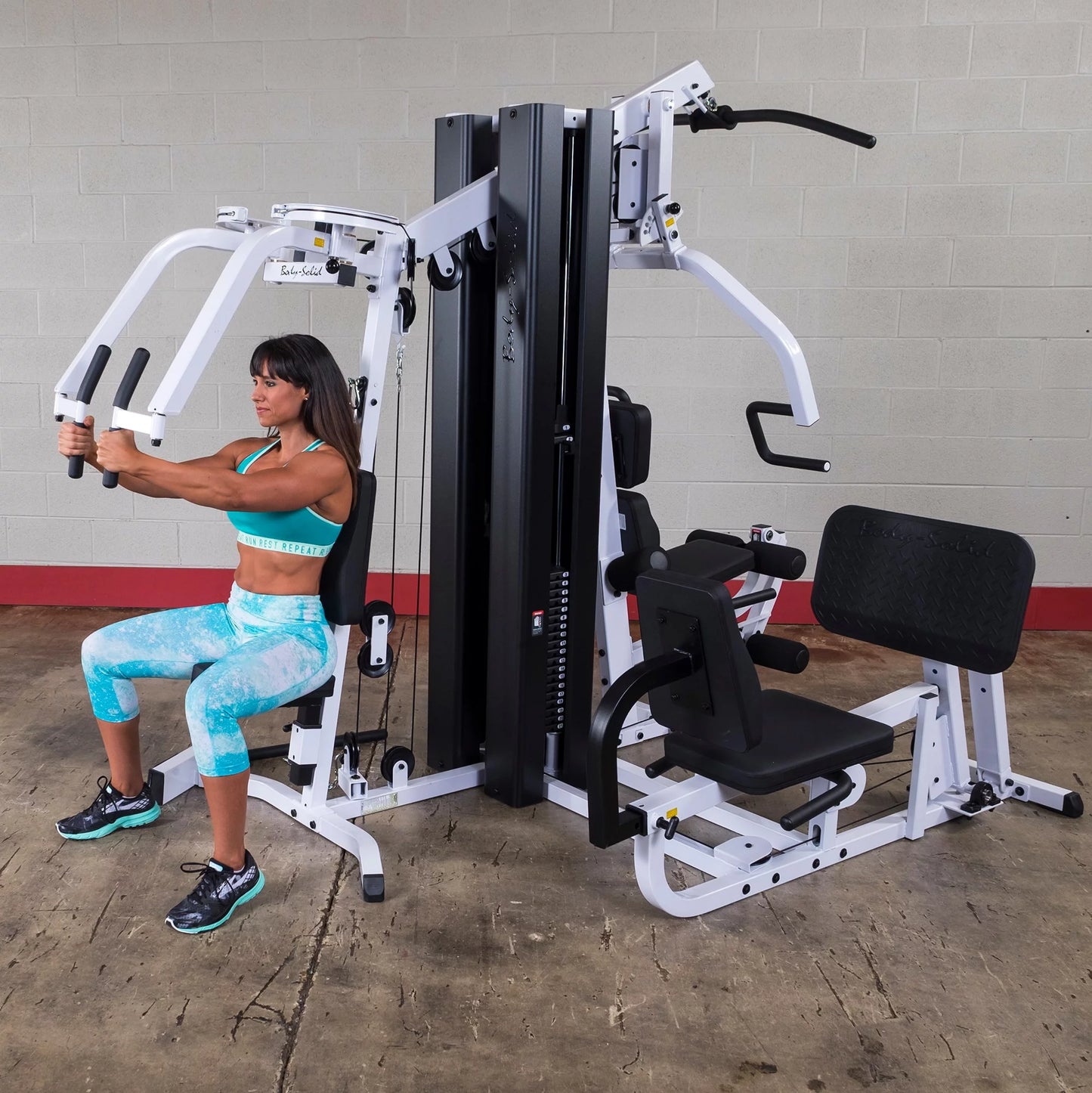 Body Solid EXM3000LPS commercial double stack gym with three workout stations and multiple weight stacks for full-body training.