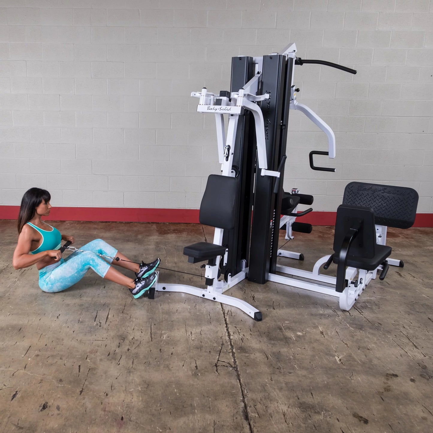 Body Solid EXM3000LPS commercial double stack gym with three workout stations and multiple strength training options.