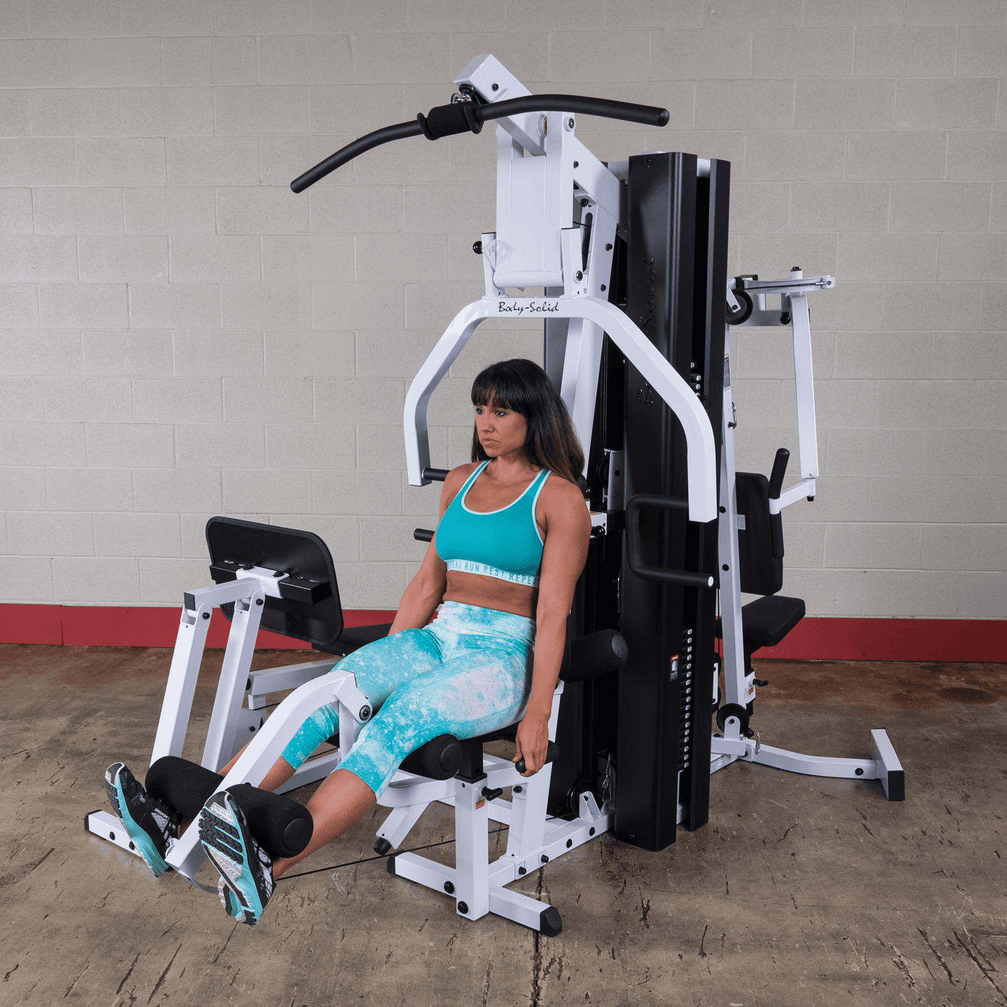 Body Solid EXM3000LPS commercial double stack gym with three workout stations and multiple weight stacks for full-body strength training.
