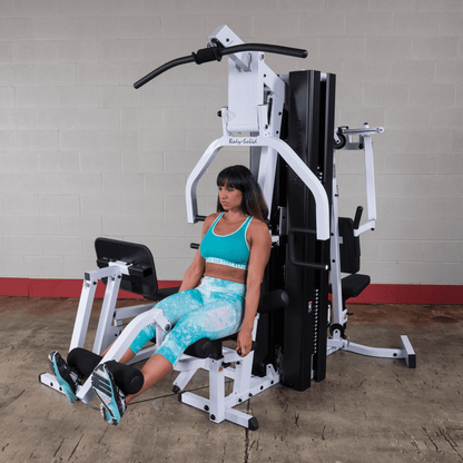 Body Solid EXM3000LPS commercial double stack gym with three workout stations and multiple weight stacks for full-body strength training.