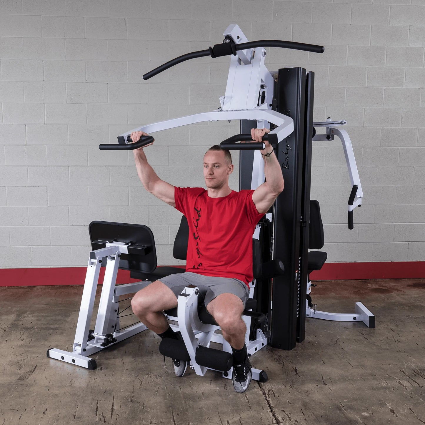 Body Solid EXM3000LPS commercial double stack gym with three workout stations and multiple weight stacks for full-body training.