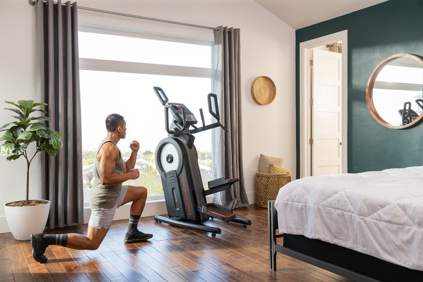 Fitness Essentials Trainer H7 iFit-enabled elliptical with 7-inch touchscreen and built-in fan, showing the sleek console and frame.