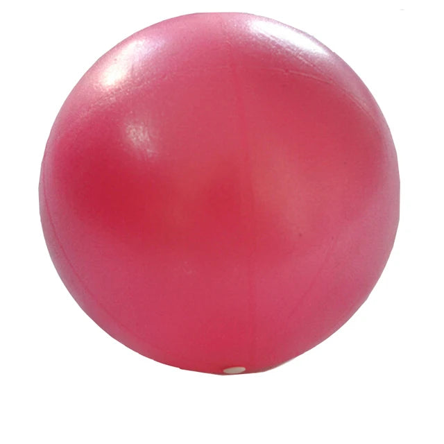 Pink 25cm Fitness Essentials yoga ball for Pilates, core training, and home workouts, shown on a clean exercise space.
