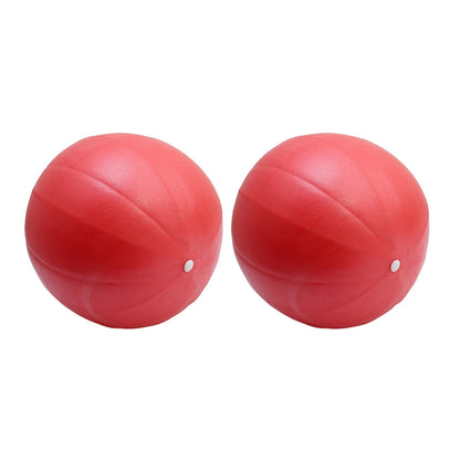 Pink 25cm Fitness Essentials yoga ball used for Pilates, core training, and home workouts, with a smooth surface and inflation valve.