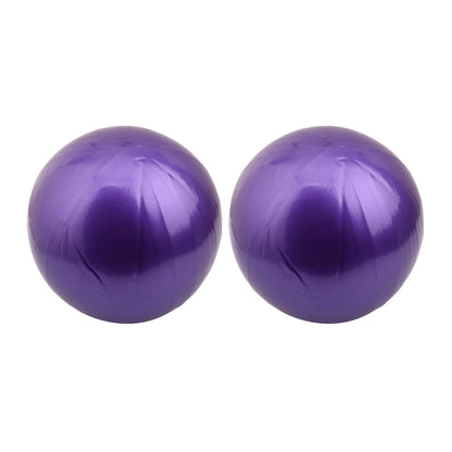 Pink 25cm Fitness Essentials yoga ball used for Pilates, core training, and home workouts, shown on a clean workout space.