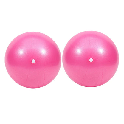 Pink 25cm Fitness Essentials yoga ball for Pilates, core training, and home workouts, shown on a clean workout mat.