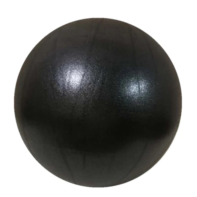 Pink 25cm Fitness Essentials yoga ball used for Pilates, core training, and home workouts in a bright gym setting.
