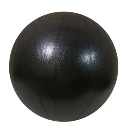 Pink 25cm Fitness Essentials yoga ball used for Pilates, core training, and home workouts in a bright gym setting.
