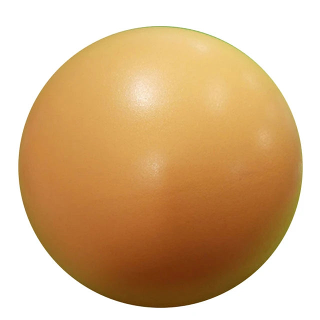 Pink 25cm Fitness Essentials yoga ball used for Pilates, core training, and home workouts in a gym setting.