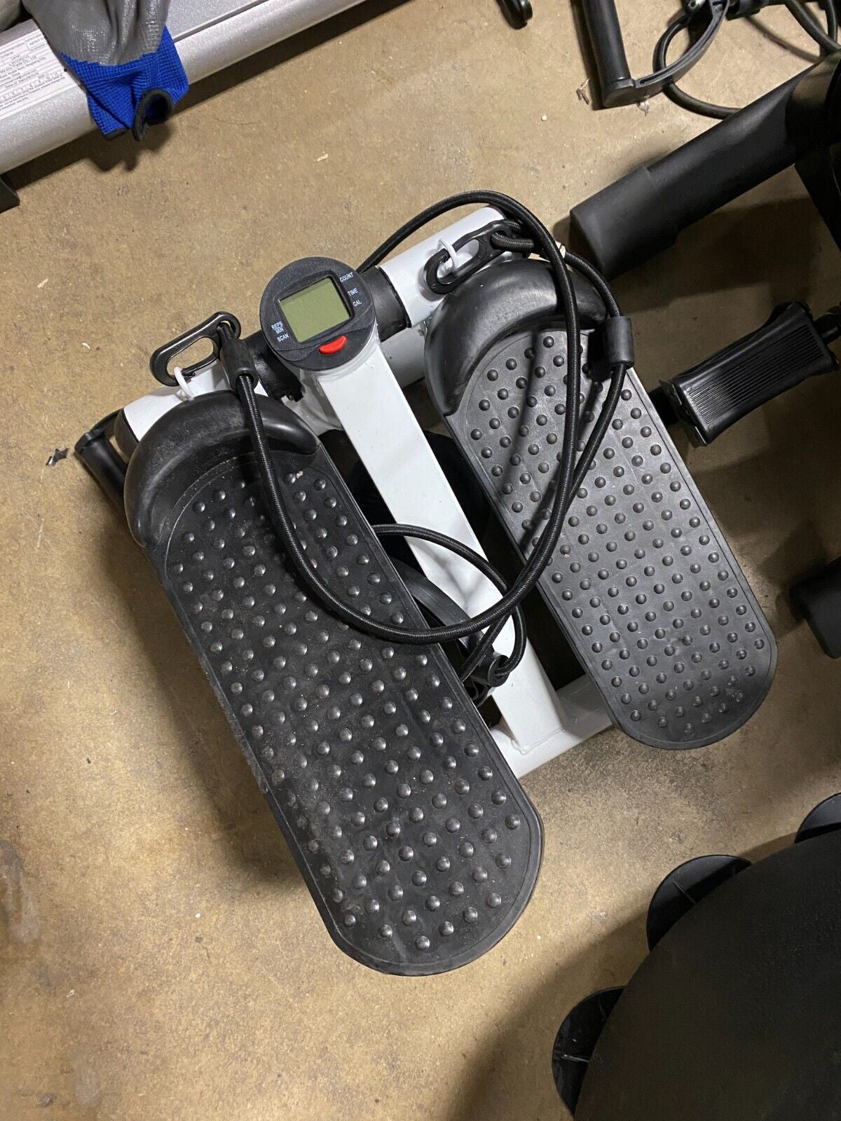 White Fitness Essentials mini stepper exercise machine with resistance bands and LCD display for home cardio workouts.