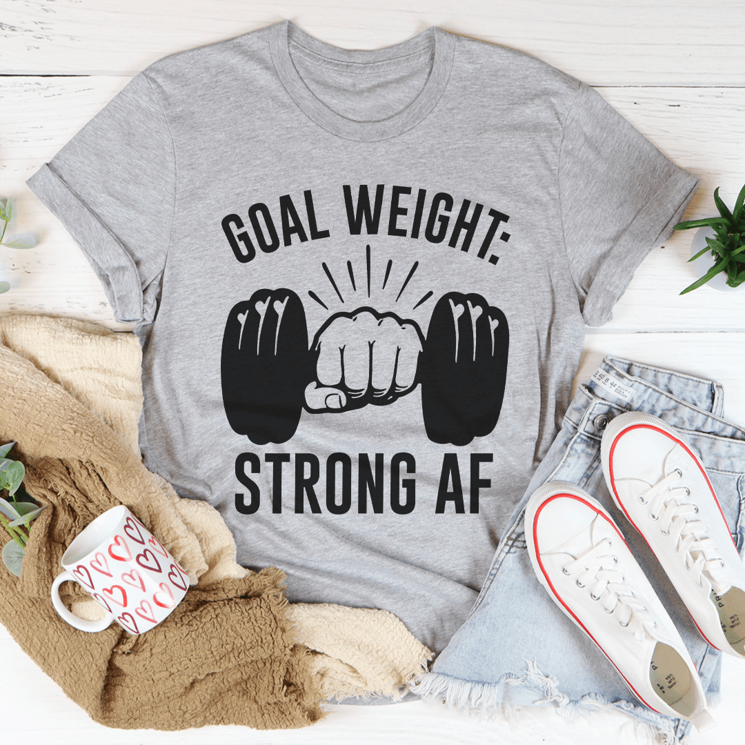 Goal weight fitness t-shirt in athletic heather color featuring bold print about strength on a stylish background.