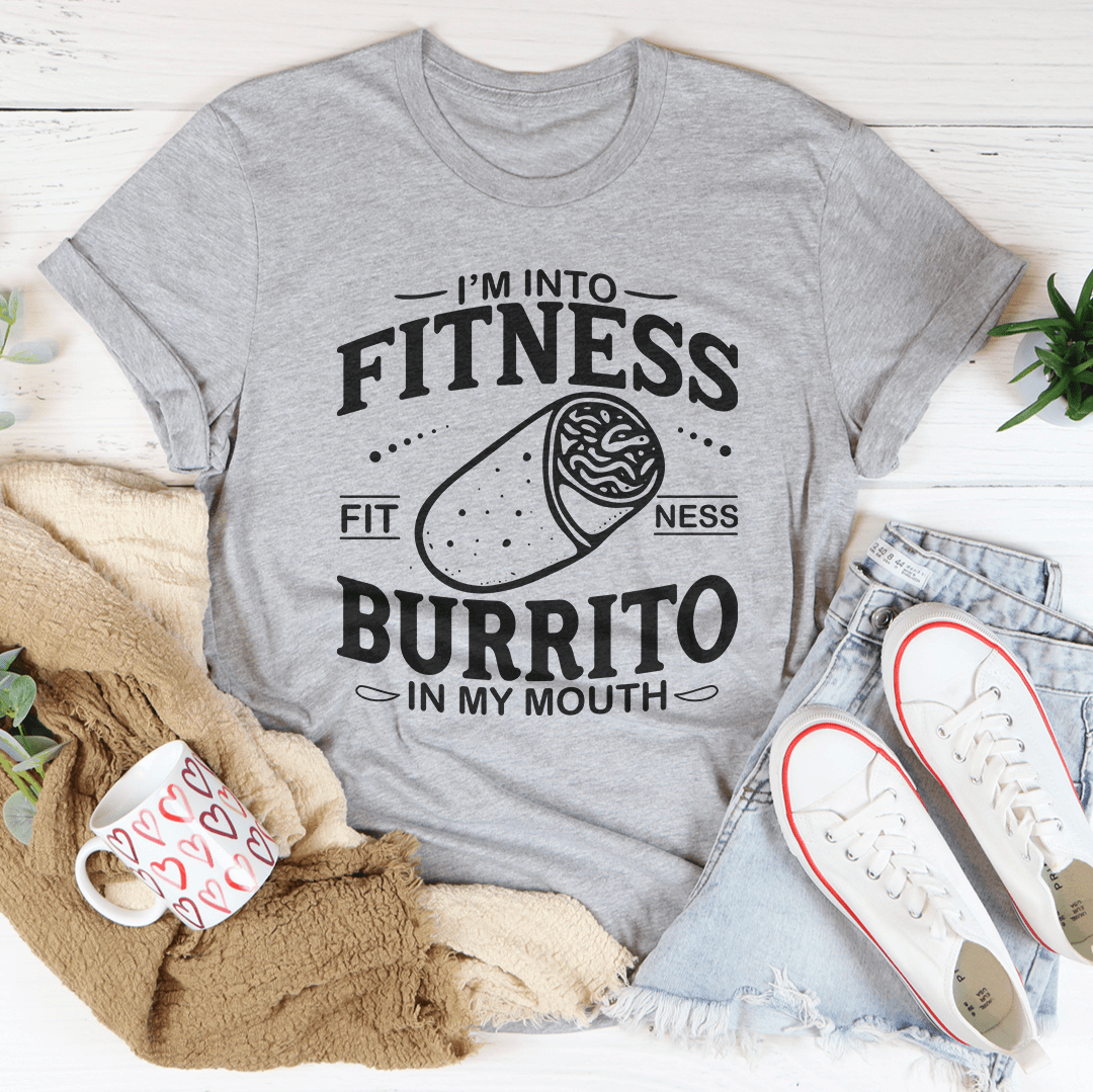 I'm Into Fitness Burrito In My Mouth Tee displayed on a flat surface showcasing fitness burrito graphic t-shirt design in Athletic Heather.