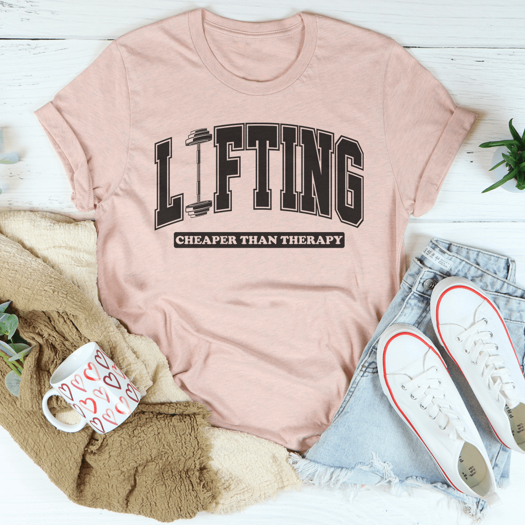 Lifting Cheaper Than Therapy Tee in Heather Prism Peach, featuring a bold lifting therapy graphic tee design.