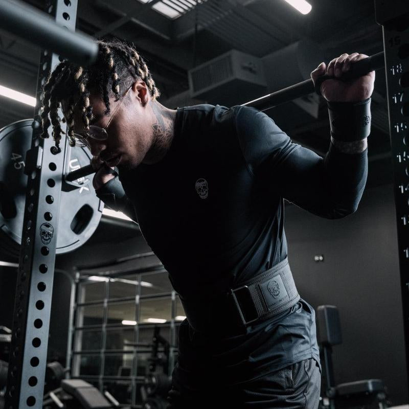 Black gym wrist wraps by My Store 2, shown wrapped around a person's wrists for support during weightlifting exercises.