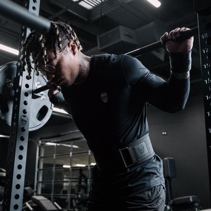 Black gym wrist wraps by My Store 2, shown wrapped around a person's wrists for support during weightlifting exercises.