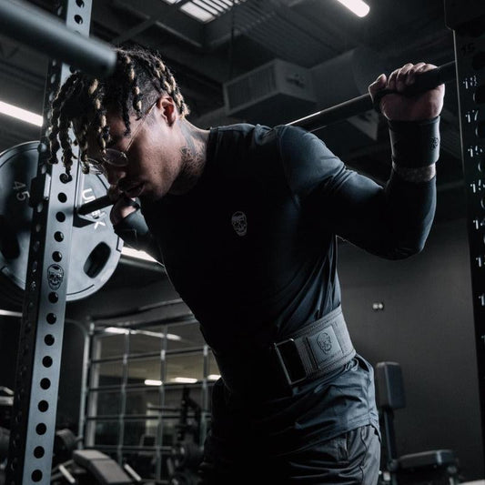 Black gym wrist wraps by My Store 2, shown wrapped around a person's wrists for support during weightlifting exercises.