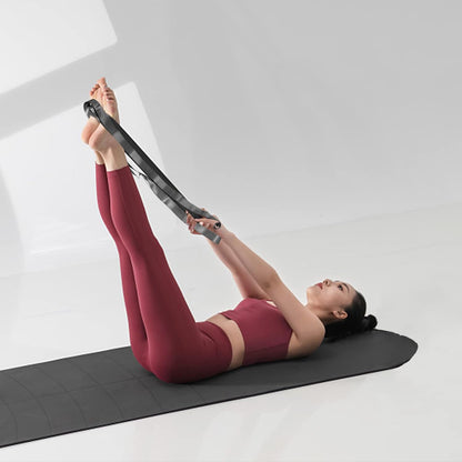 Black and grey yoga stretching straps with 12 loops, used for exercise, Pilates, physical therapy, and gymnastics for men and women.