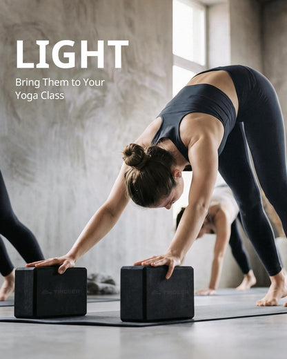 Pair of black My Store 2 yoga blocks made of soft non-slip foam with beveled edges for yoga, Pilates, and dance stretching.