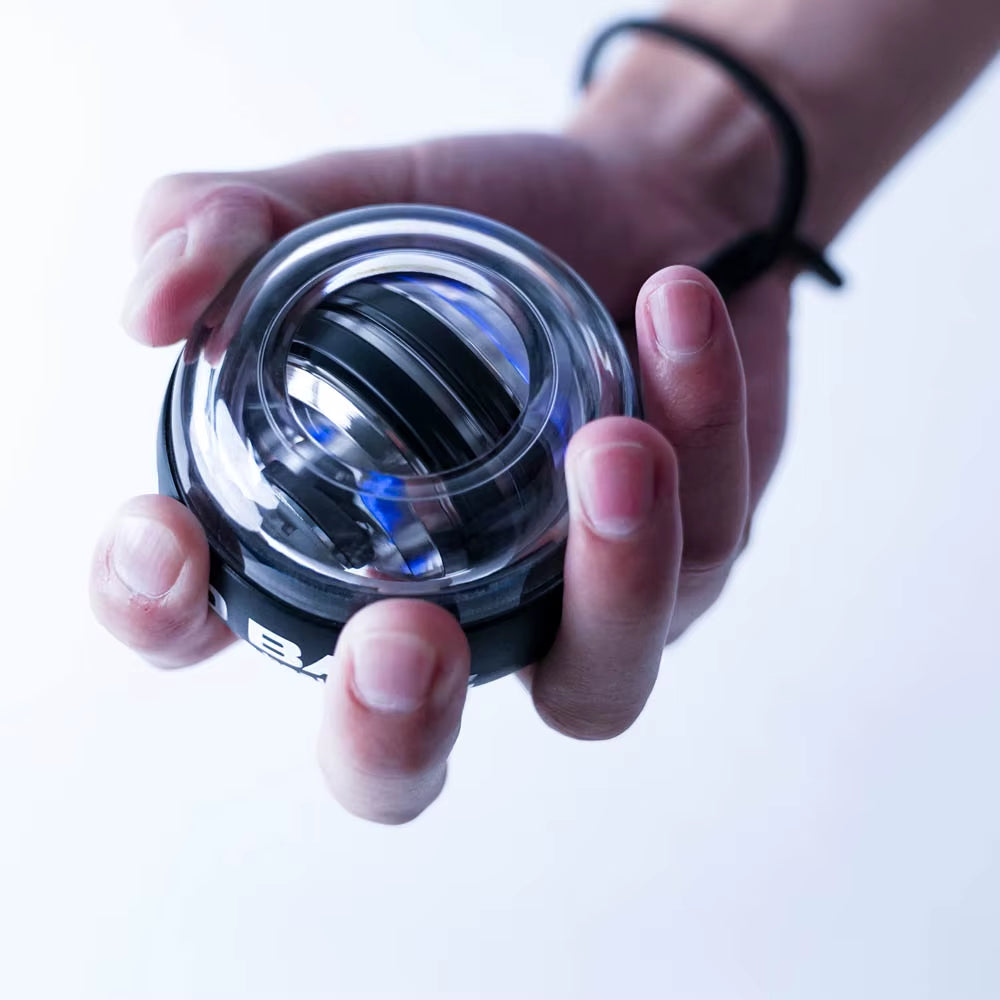 My Store 2 GyroForce™ LED Power Wrist Ball with multi-color lights showing in use for strength training and muscle grip exercise.