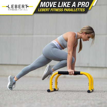 Yellow parallette push-up bars and dip station stand for home gym, suitable for gymnastics, calisthenics, and strength training.
