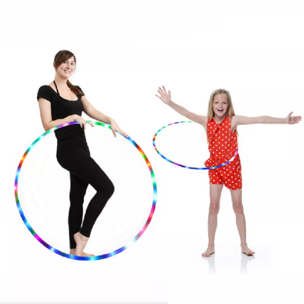 Two women playing with color changing LED fitness hoop, showcasing fun and active lifestyle with colorful lights.