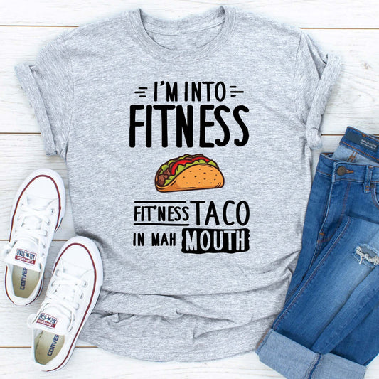 I'm Into Fitness graphic t-shirt featuring humorous taco design, ideal for casual wear and active routines.